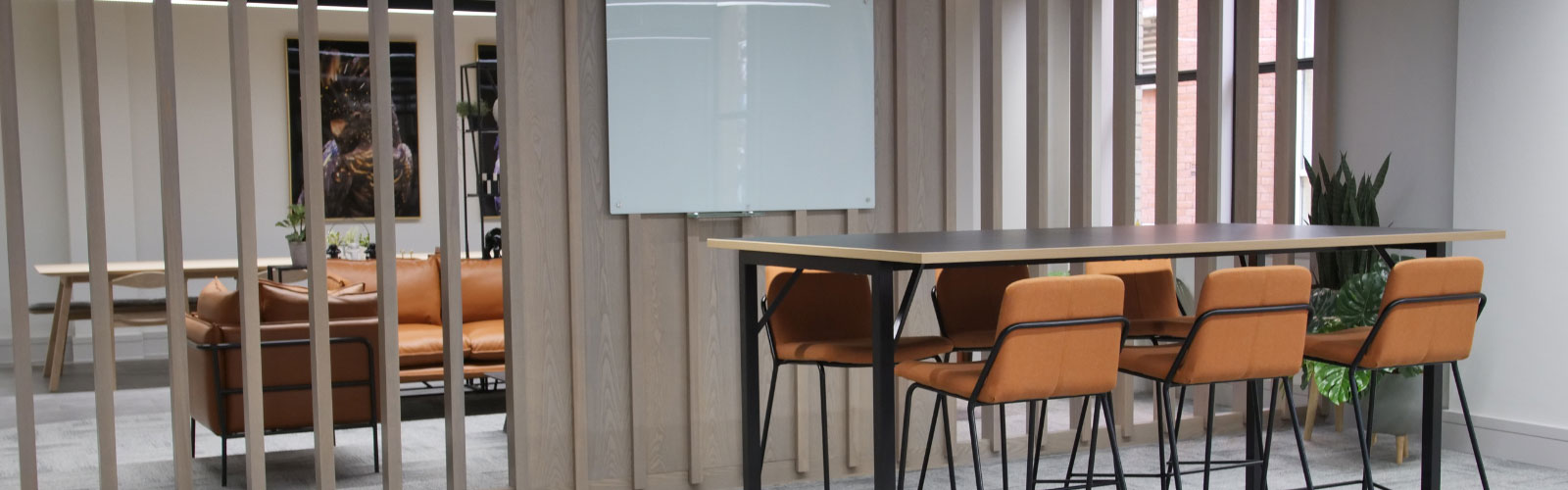 social space in office with leather couches and matching leather chairs