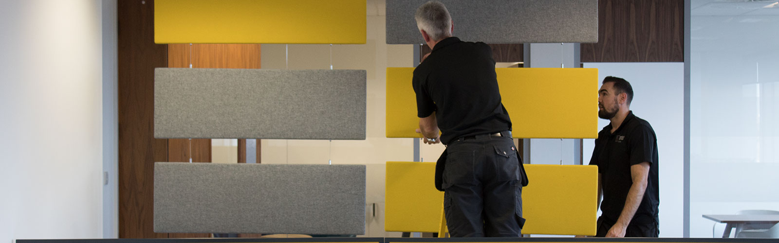 Penketh Interiors office fit out experts installing yellow and grey furniture