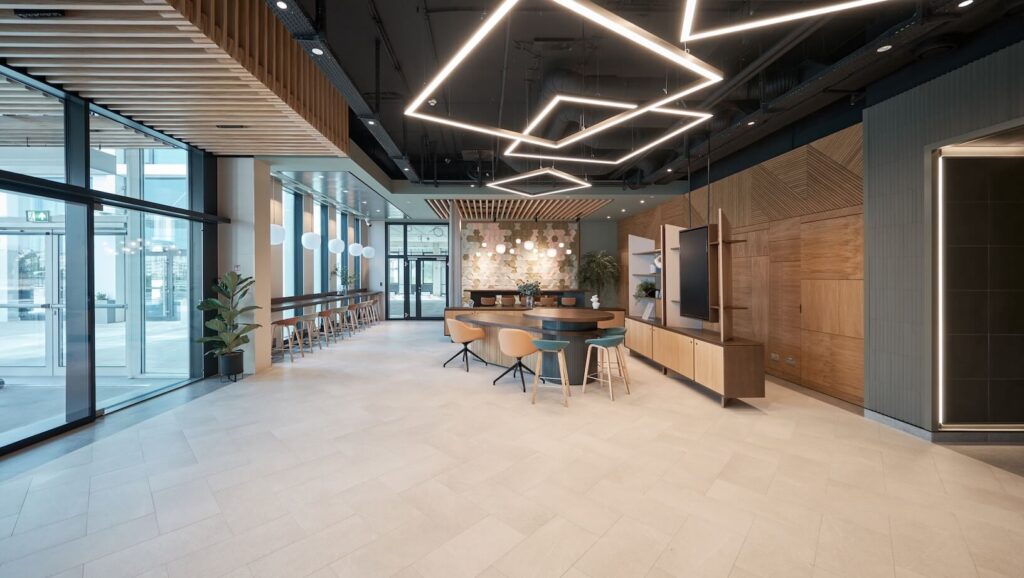 Modern interior with light wood furniture and contemporary geometric lighting on a black ceiling