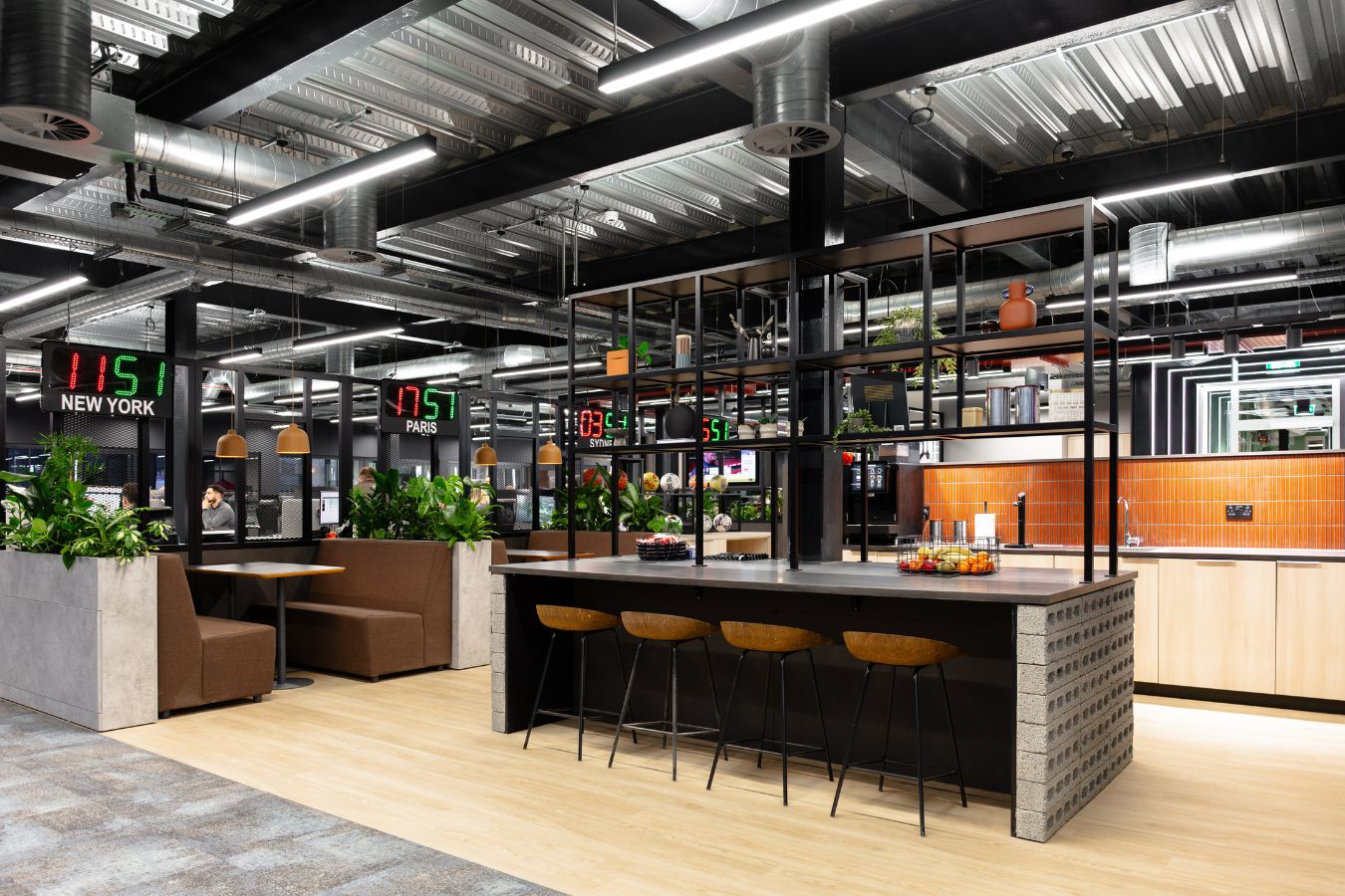 Communal office social space with biophilic décor in open plan room and collaboration spaces throughout