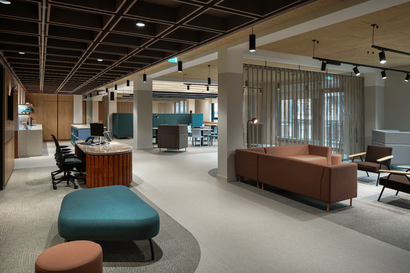 Well lit atmospheric communal area with soft seating, open kitchen and a reception