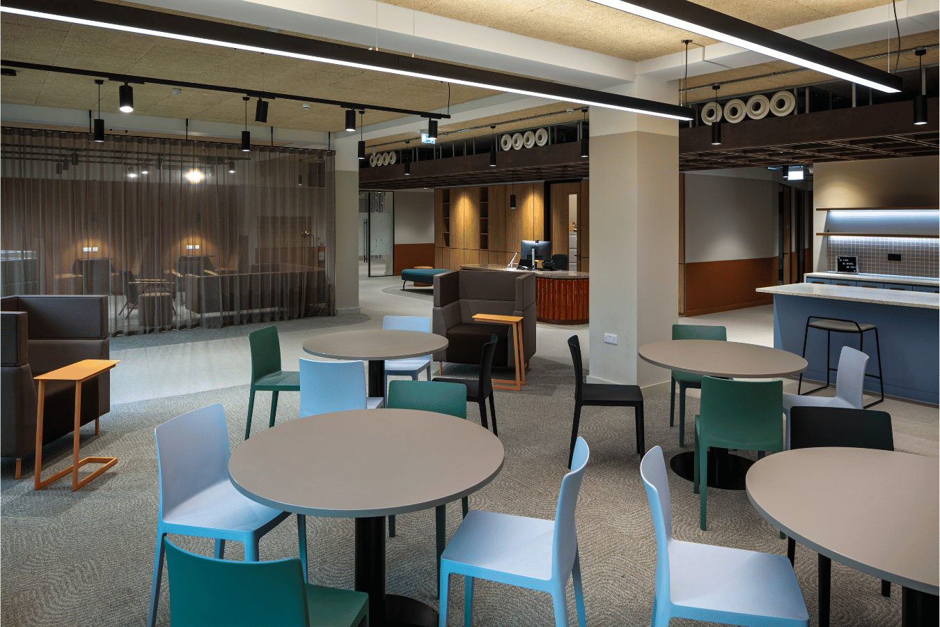 Modern communal space in office with multiple seating options