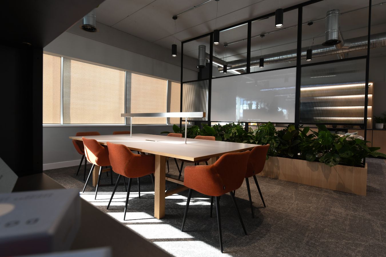 Comfortable breakout seating area with whiteboard separated by acoustic panelling