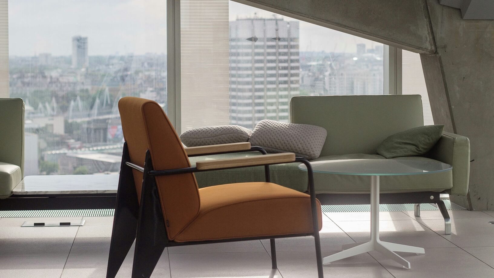 Modern office furniture against a glass window with a view over central London