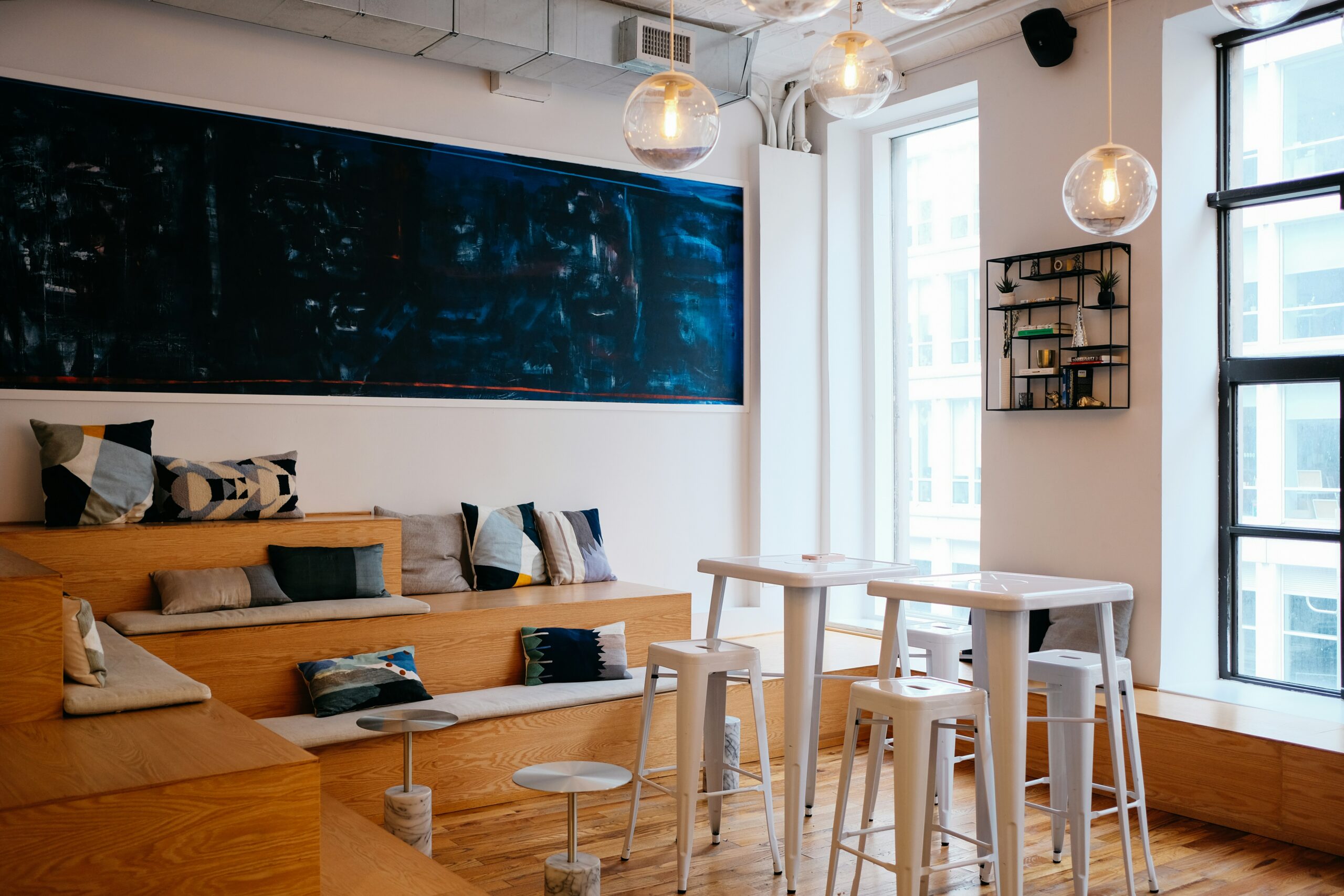 Bleacher style seating overlooking a floor to ceiling window in a creative studio office in London